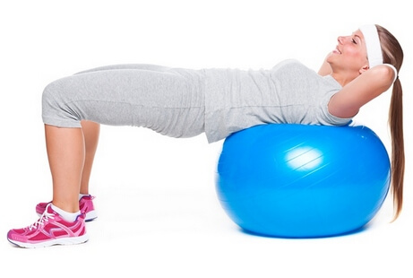 Woman doing exercise on ball for abs